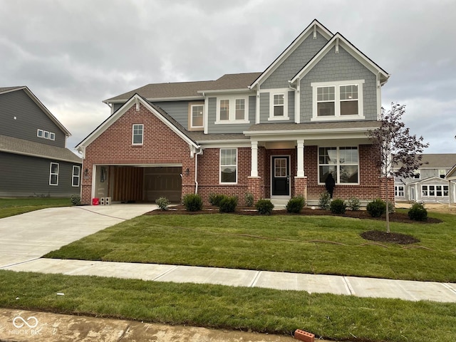 craftsman-style house with brick siding, concrete driveway, a garage, and a front yard