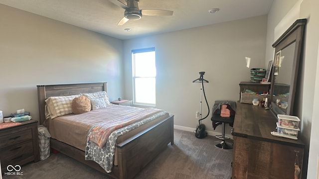 carpeted bedroom featuring baseboards and a ceiling fan