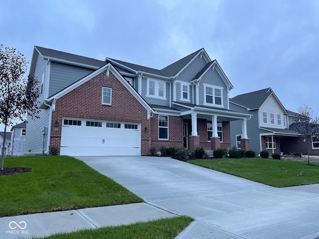 craftsman inspired home with brick siding, concrete driveway, and a front yard