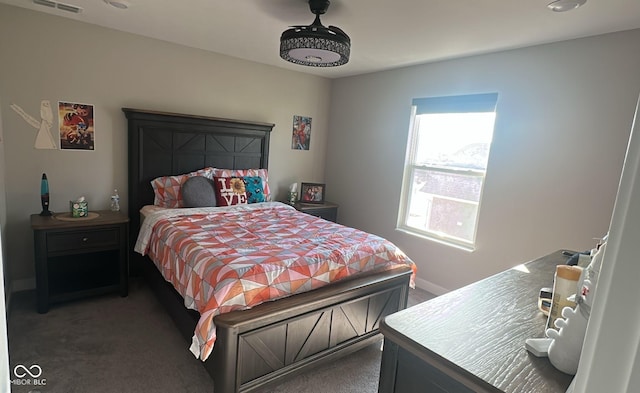 carpeted bedroom featuring baseboards and visible vents