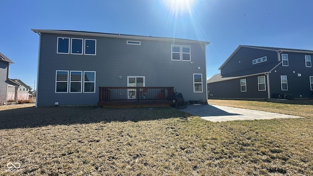 rear view of house with a patio, a yard, and a wooden deck