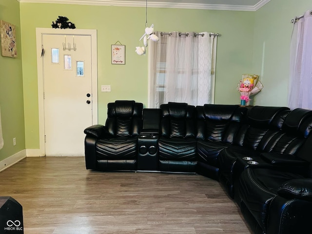 living area with wood finished floors and ornamental molding