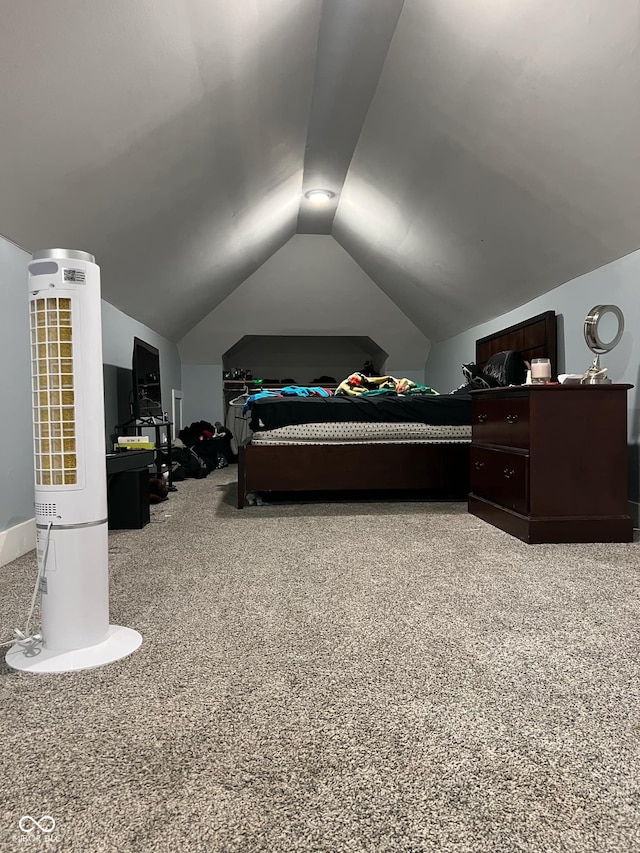 carpeted bedroom featuring lofted ceiling