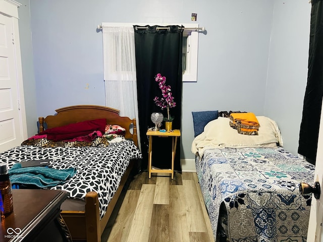 bedroom featuring wood finished floors