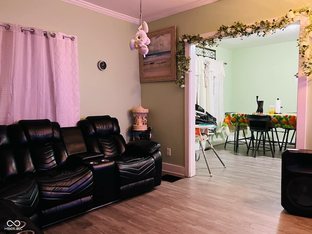 interior space with crown molding, wood finished floors, and baseboards