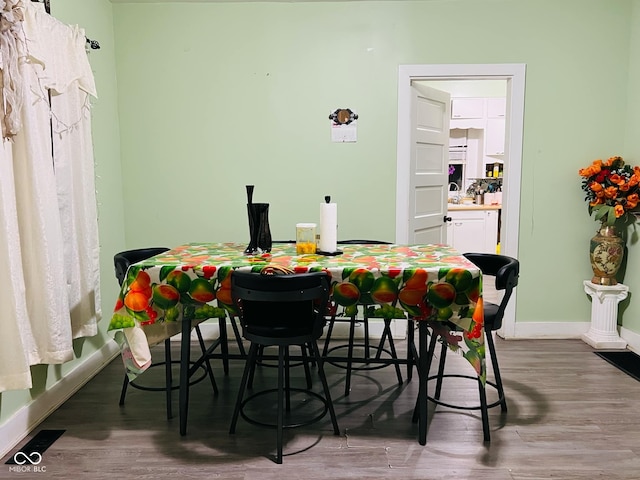 dining area featuring wood finished floors and baseboards