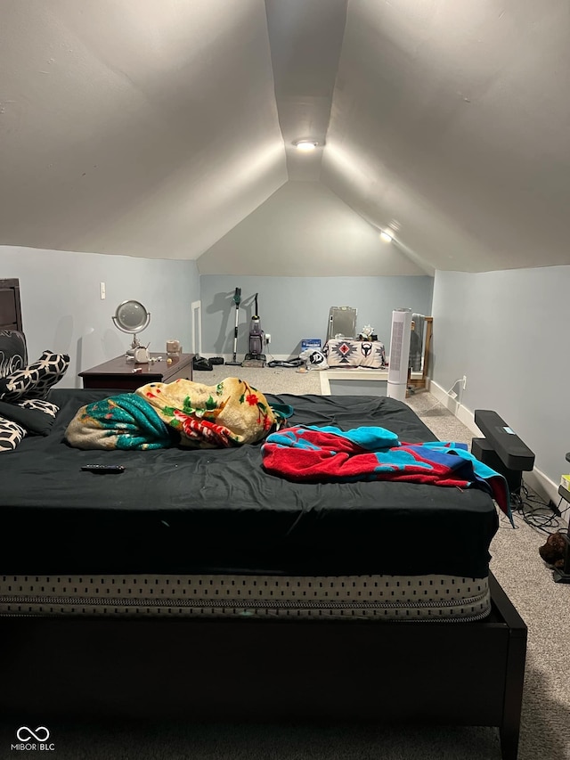 bedroom with vaulted ceiling, carpet, and baseboards