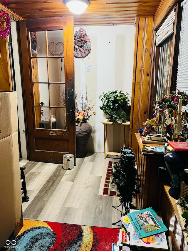 interior space with wood ceiling and wood finished floors