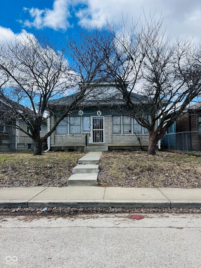 view of front of home featuring fence