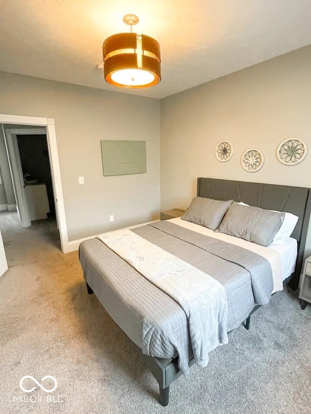 bedroom with light colored carpet and baseboards