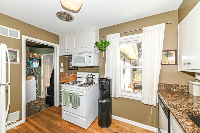 kitchen with visible vents, white appliances, and light wood-style floors