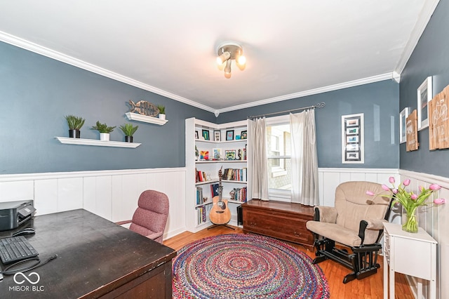 home office featuring a wainscoted wall, crown molding, and wood finished floors