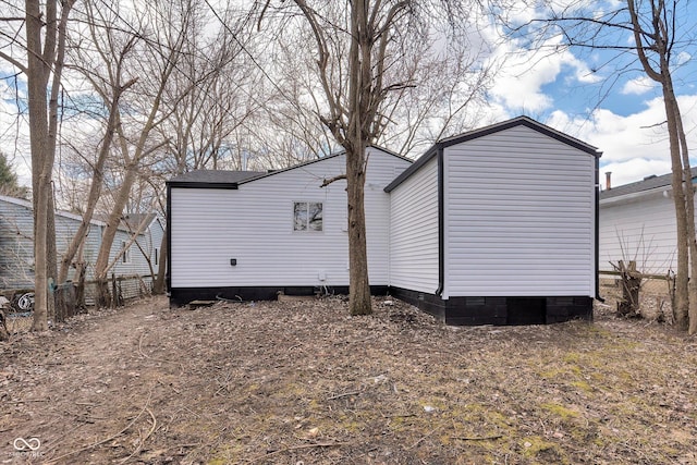 view of home's exterior featuring fence