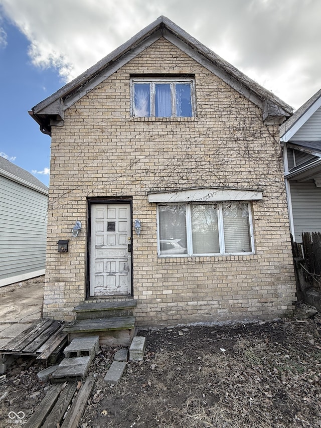 view of front facade with brick siding and entry steps