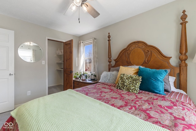 bedroom featuring a closet, carpet floors, ceiling fan, and a spacious closet