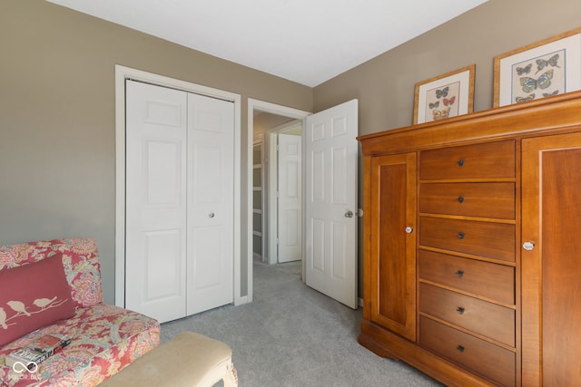 bedroom with light carpet and a closet