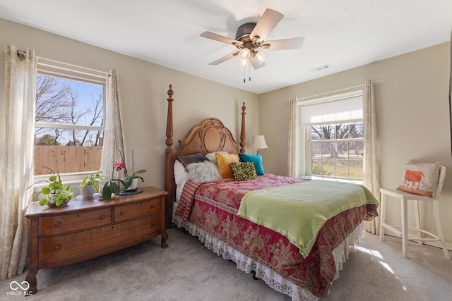 bedroom with multiple windows, carpet, visible vents, and ceiling fan