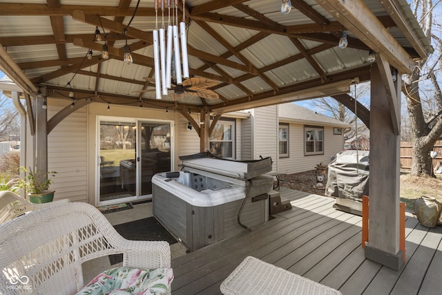 wooden deck with a gazebo and a hot tub