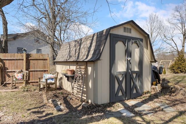 view of shed featuring fence