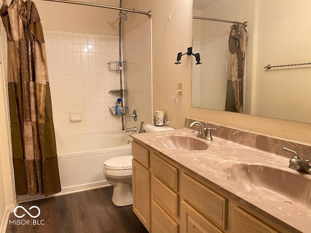 bathroom with wood finished floors, a sink, toilet, and shower / bathtub combination with curtain