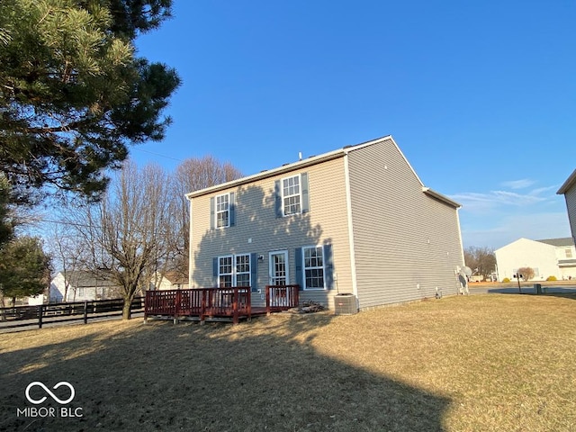 back of property featuring a deck, central AC unit, a lawn, and fence