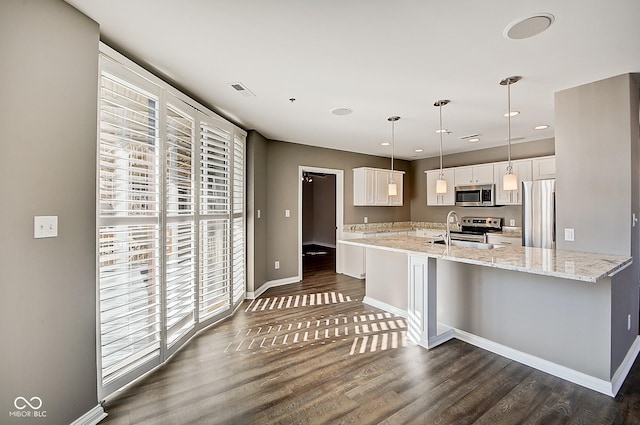 kitchen with baseboards, dark wood finished floors, a sink, white cabinets, and appliances with stainless steel finishes