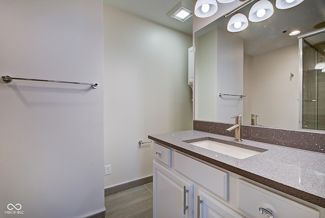 full bathroom with a shower, baseboards, and vanity