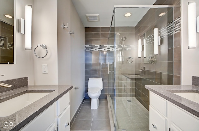 full bathroom featuring a sink, visible vents, two vanities, and a shower stall