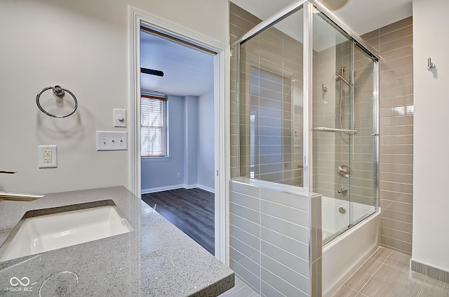 bathroom with enclosed tub / shower combo and vanity