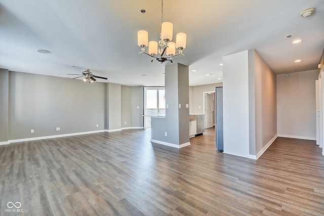 interior space featuring recessed lighting, baseboards, dark wood-style floors, and ceiling fan with notable chandelier