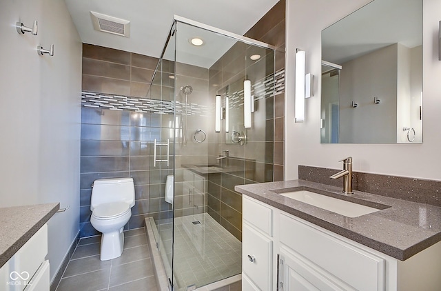 full bath with visible vents, toilet, a stall shower, and vanity