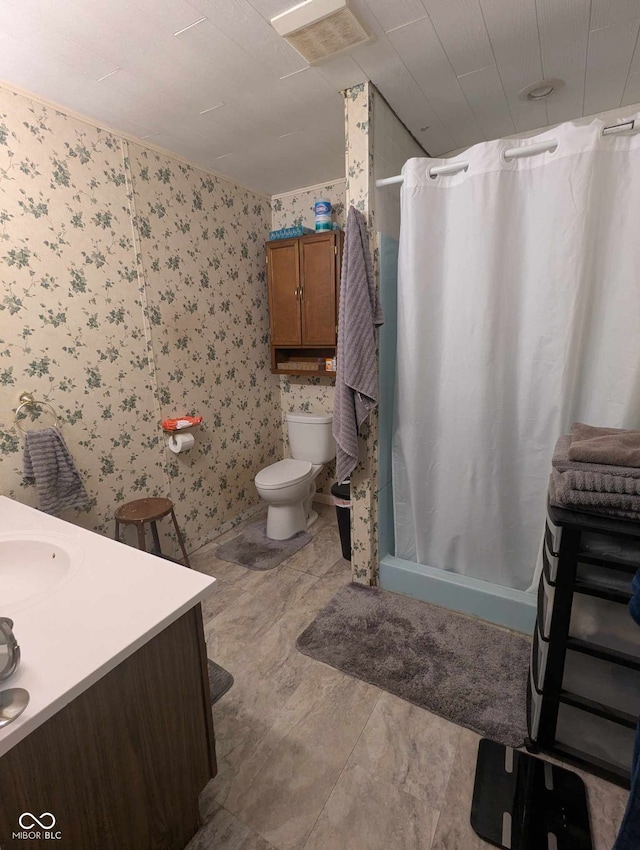 bathroom featuring toilet, wallpapered walls, a shower stall, and vanity