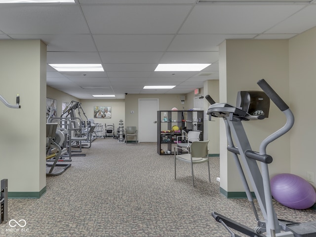 workout area with baseboards, a paneled ceiling, and carpet