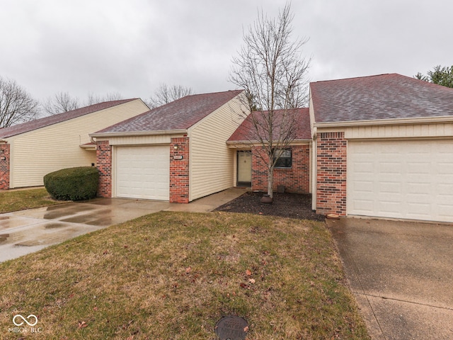 ranch-style home featuring driveway, roof with shingles, a front lawn, a garage, and brick siding