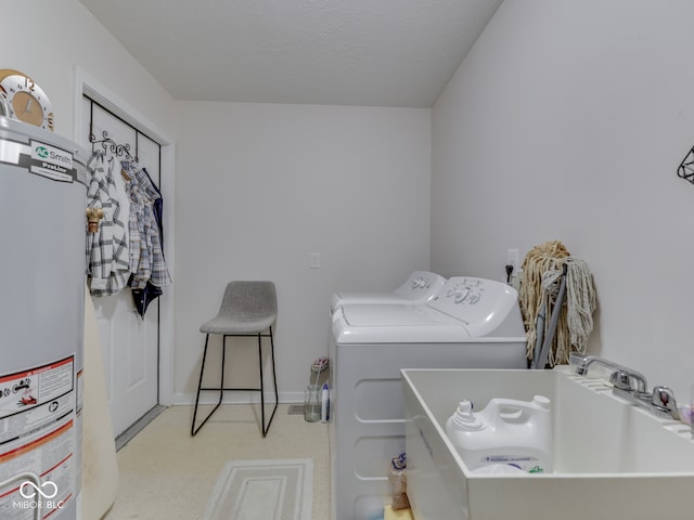 clothes washing area featuring laundry area, a sink, a textured ceiling, gas water heater, and washing machine and dryer