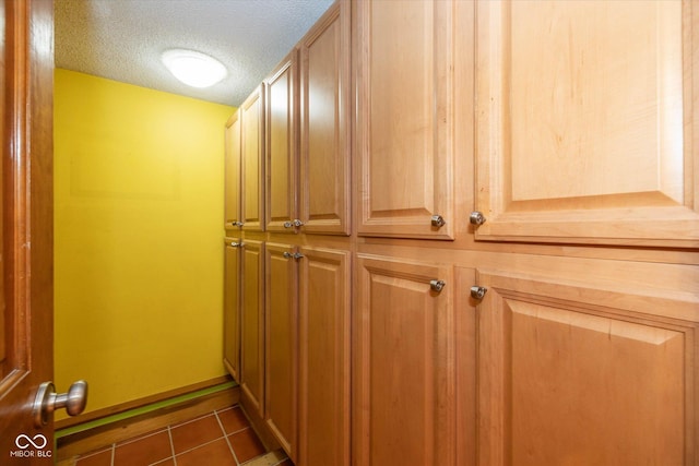 interior space featuring baseboards and a textured ceiling