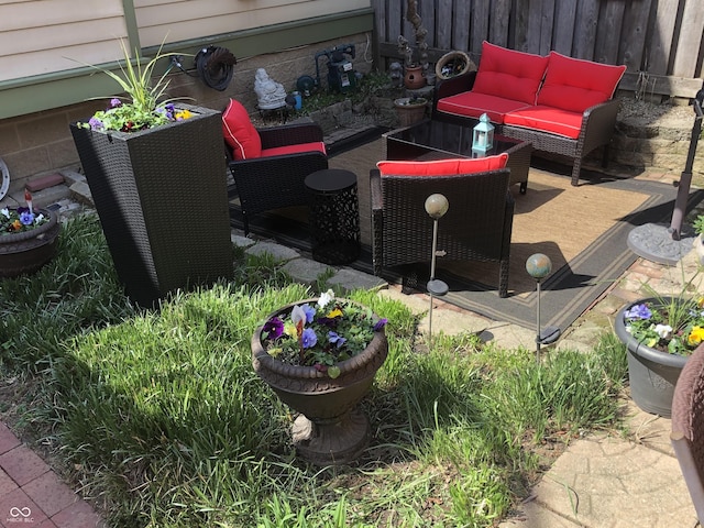 view of patio featuring an outdoor hangout area and fence