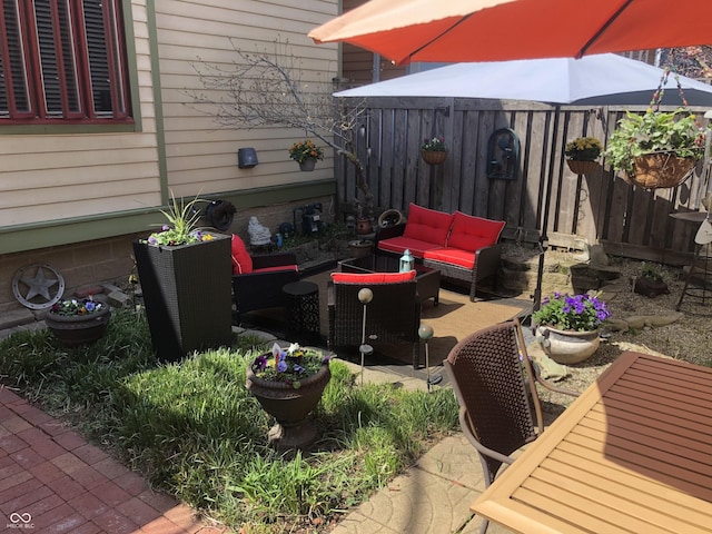 view of patio with an outdoor hangout area and fence