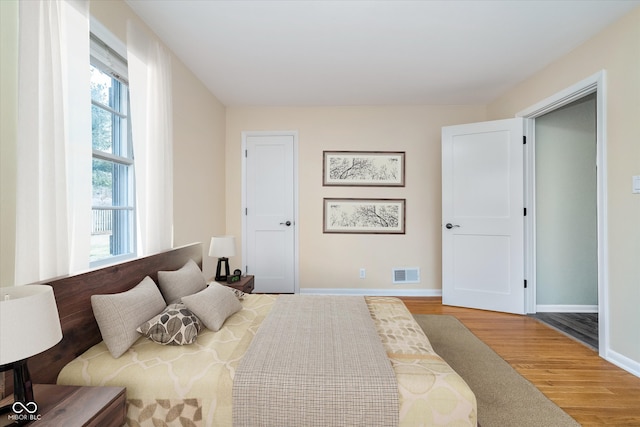 bedroom featuring wood finished floors and baseboards