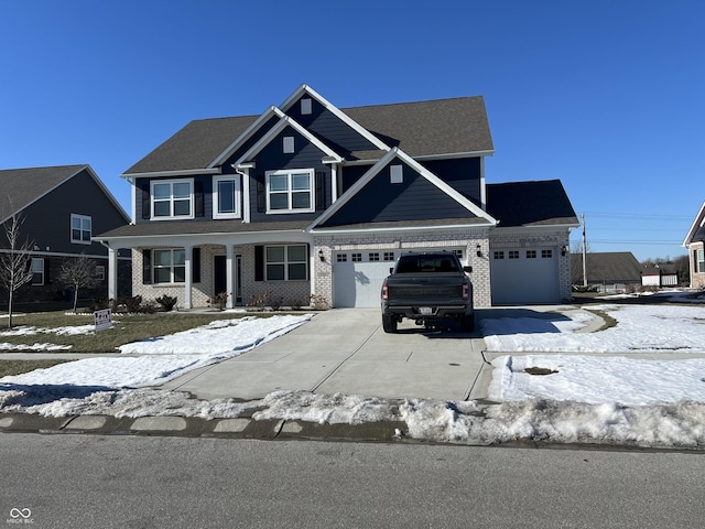 view of front of property featuring concrete driveway and brick siding