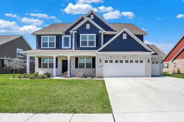 craftsman inspired home featuring a garage, a front yard, concrete driveway, and brick siding