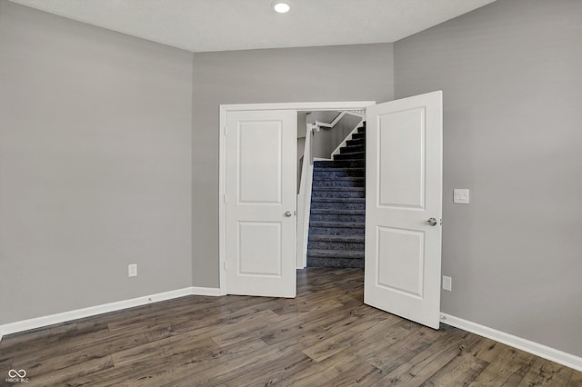 unfurnished bedroom featuring recessed lighting, baseboards, and wood finished floors