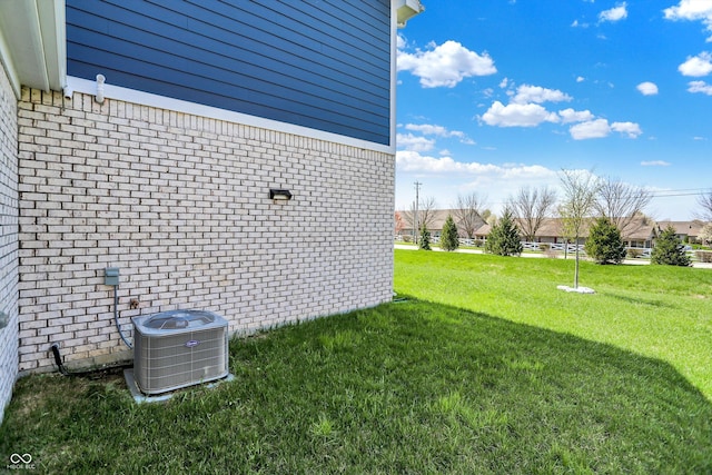 view of yard featuring a residential view and central air condition unit