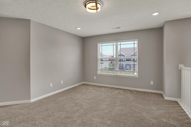 carpeted empty room with recessed lighting, visible vents, baseboards, and a textured ceiling