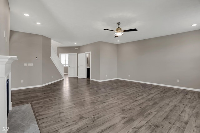 unfurnished living room with recessed lighting, dark wood-type flooring, baseboards, and ceiling fan
