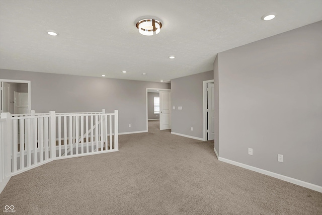 empty room with baseboards, recessed lighting, and carpet flooring