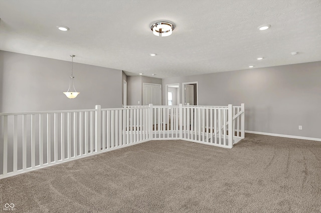 carpeted empty room with baseboards and recessed lighting