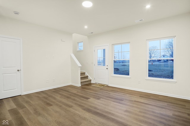 entryway featuring visible vents, wood finished floors, recessed lighting, baseboards, and stairs