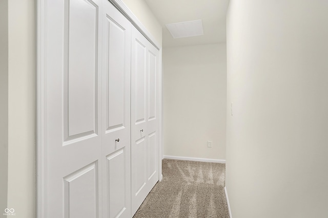 hallway featuring baseboards and carpet floors