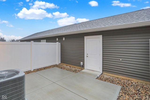 view of patio featuring cooling unit and fence